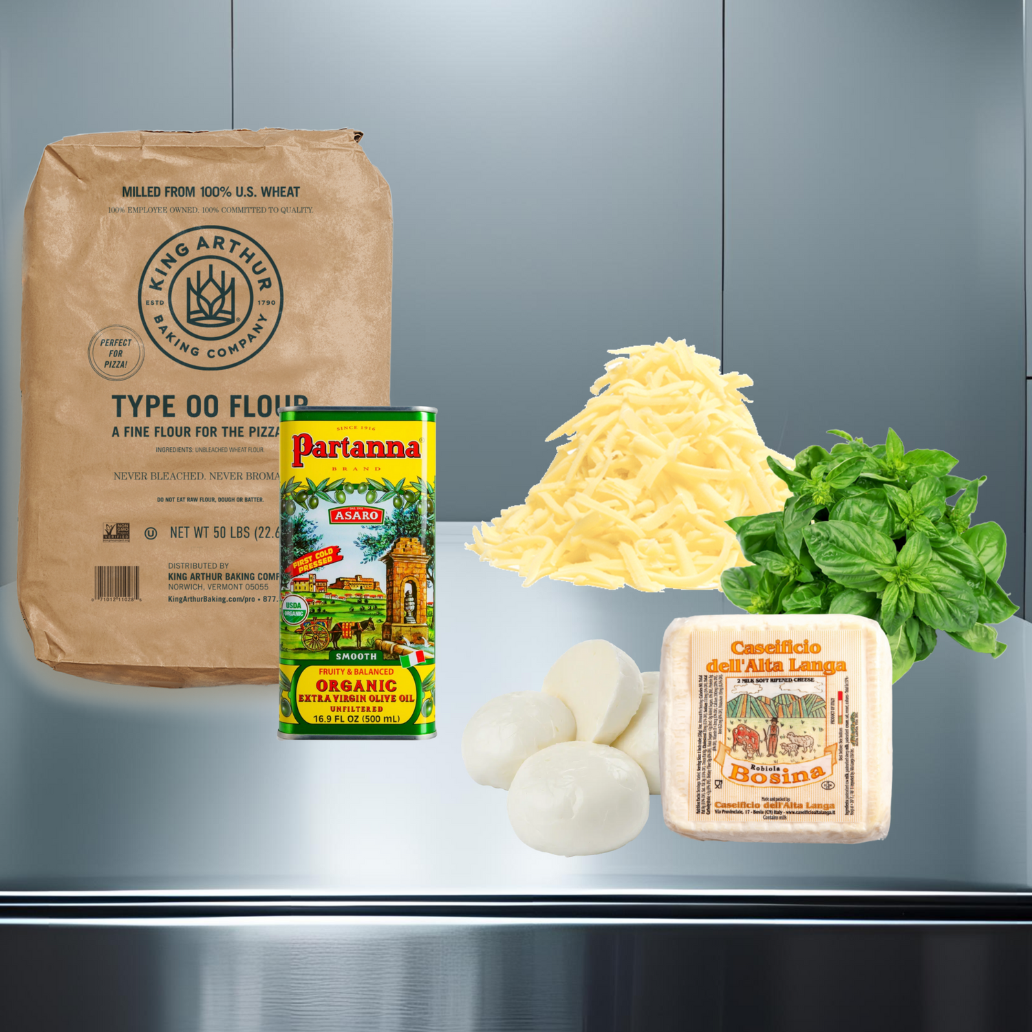 Ingredients for pizza on a metallic surface with a gray background